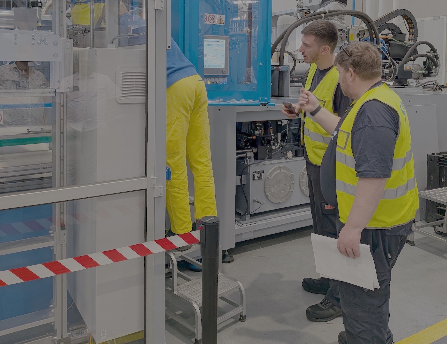 Engineers reviewing a newly installed packaging machine during